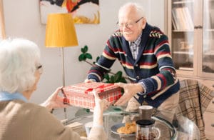 old man giving wife an anniversary gift