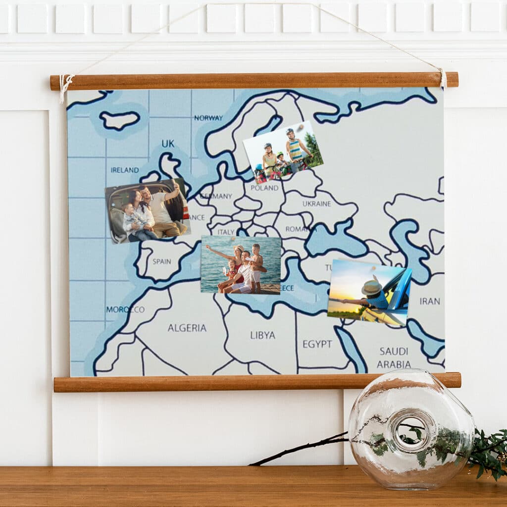 Family trip prints pinned on a map of Europe hanging on a wall
