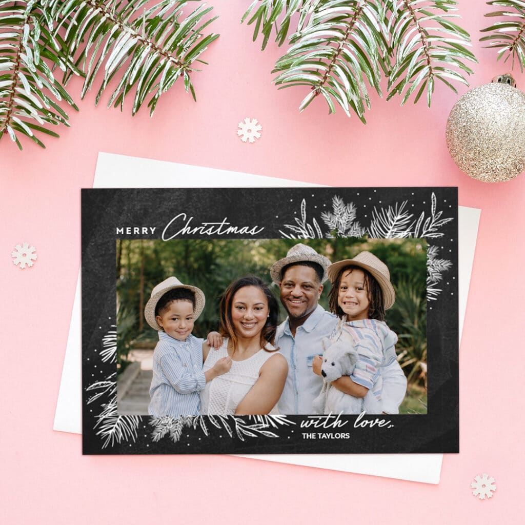 a merry Christmas card presented on a pink surface with little white stars
