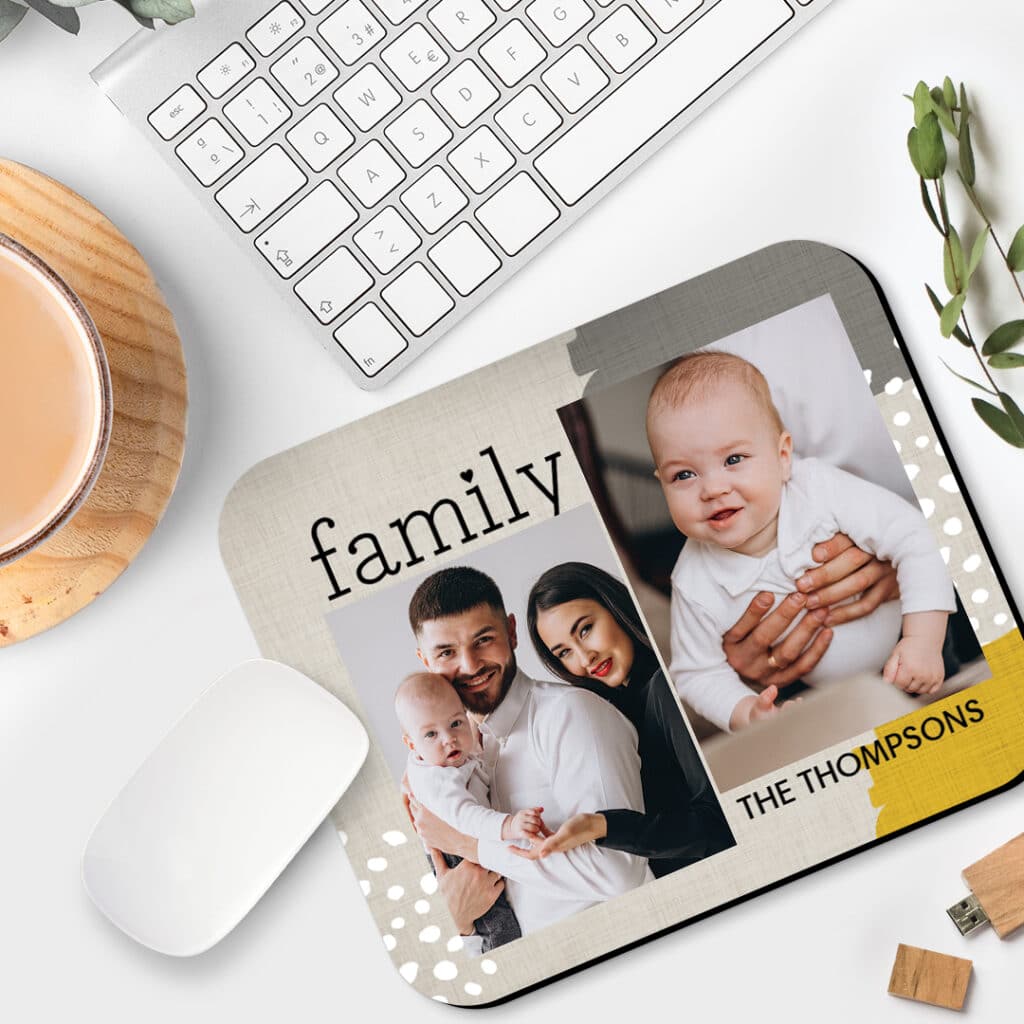 a mousepad with lovely young family photos presented on a work desk 