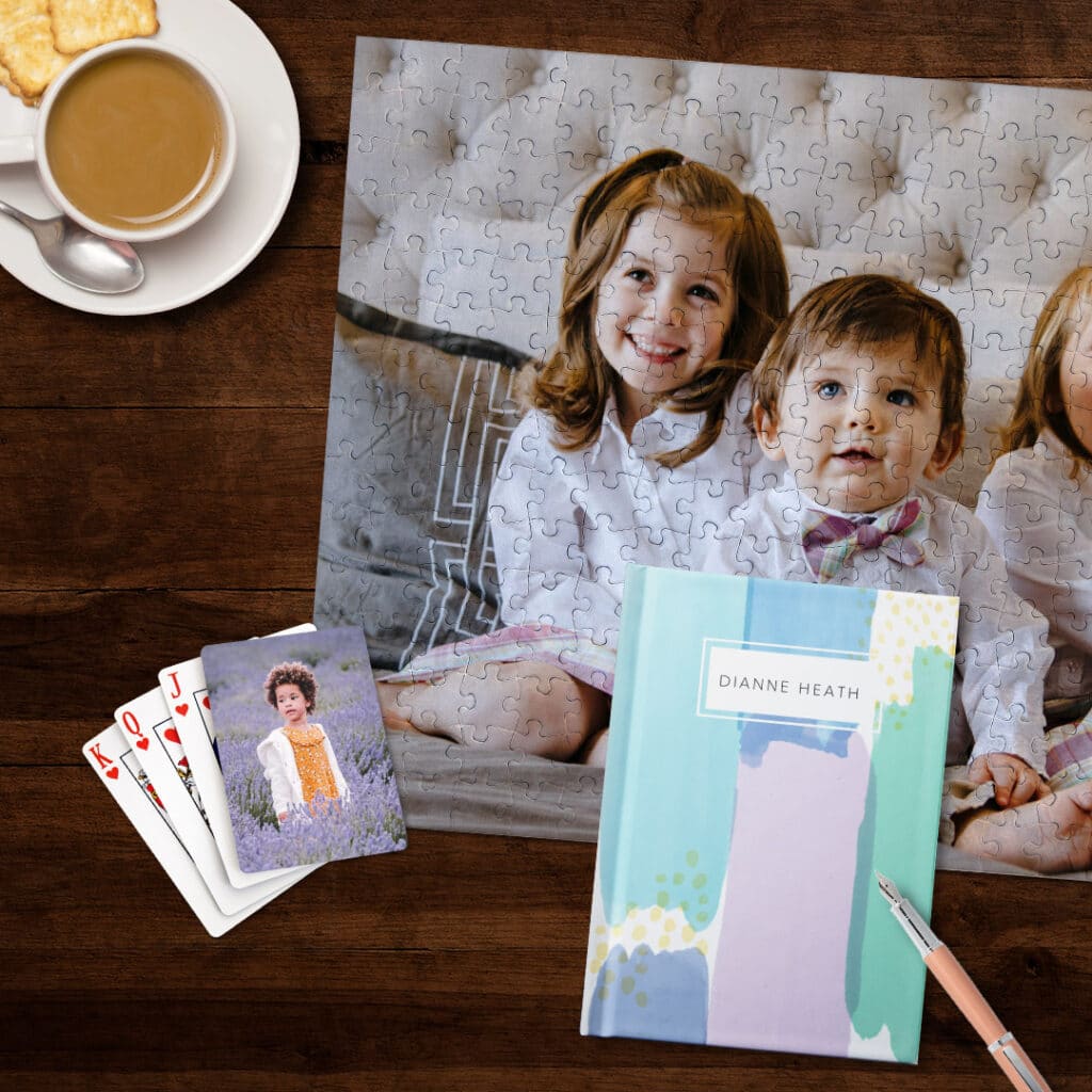 puzzle cards. playing cards and journal next to tea

