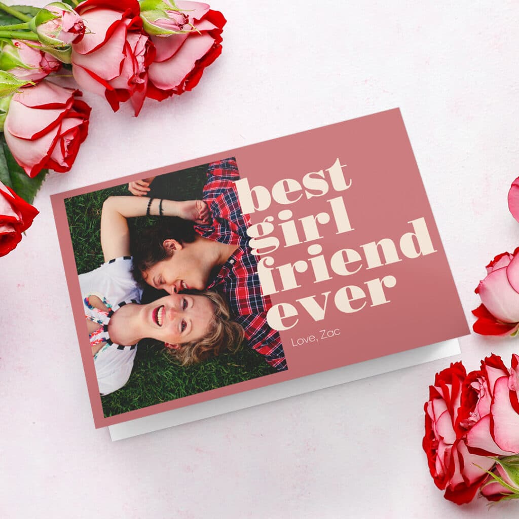'Best girlfriend ever' Valentine's day card design with a photo of a lovely couple lying on the grass