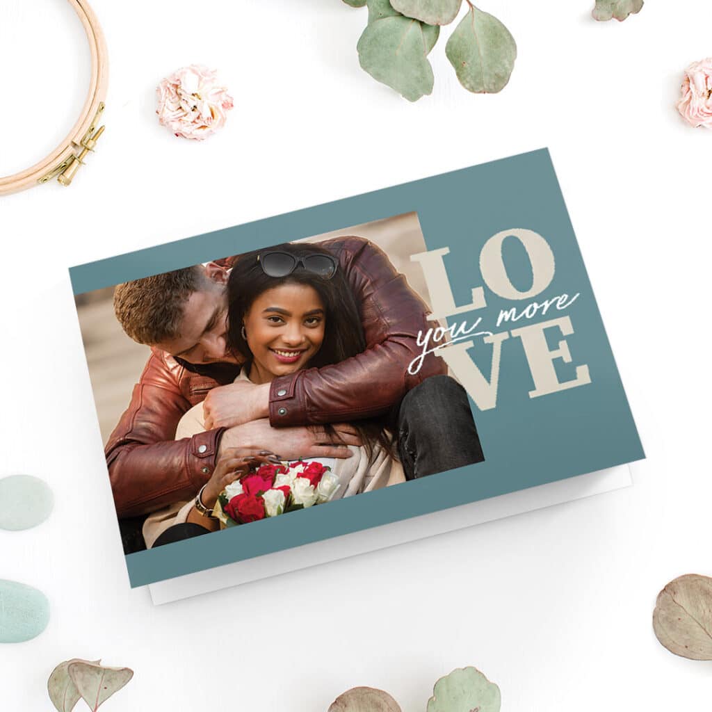 A lovely Valentine's day card with a photo of a happy couple and big letters 'love' on it
