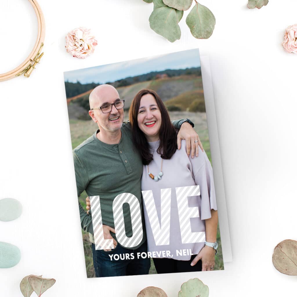 A lovely Valentine's day card with a photo of a happy couple and big letters 'love' on it