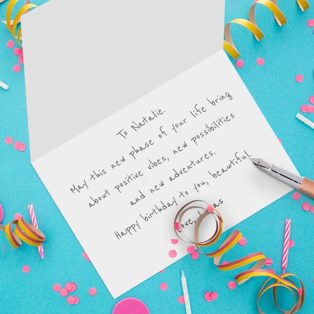 open birthday card on teal and confetti background