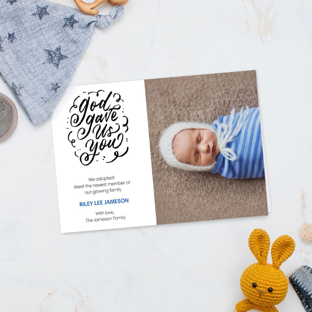 Baby boy announcement card displayed on a blue surface