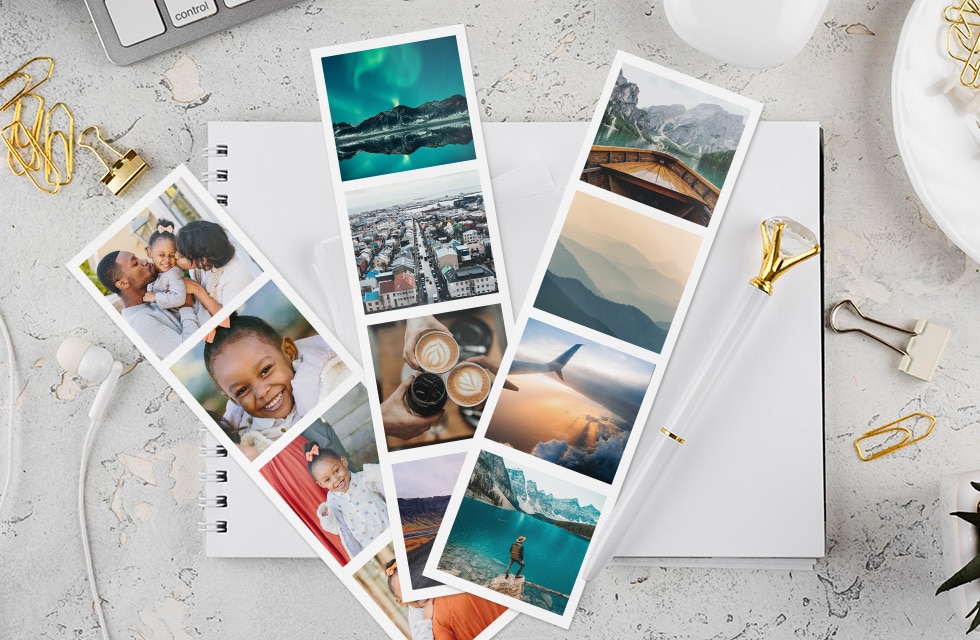 three photo booth-style strips on a note book on a desk