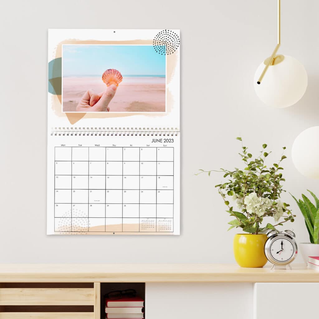 Wall calendar featuring image of hand holding a shell