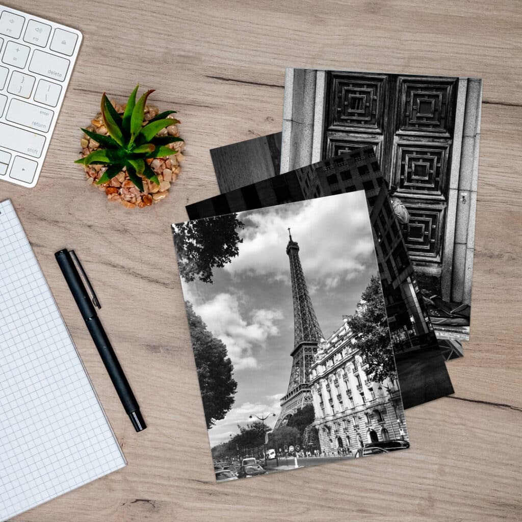 Black and white photo prints on a desk