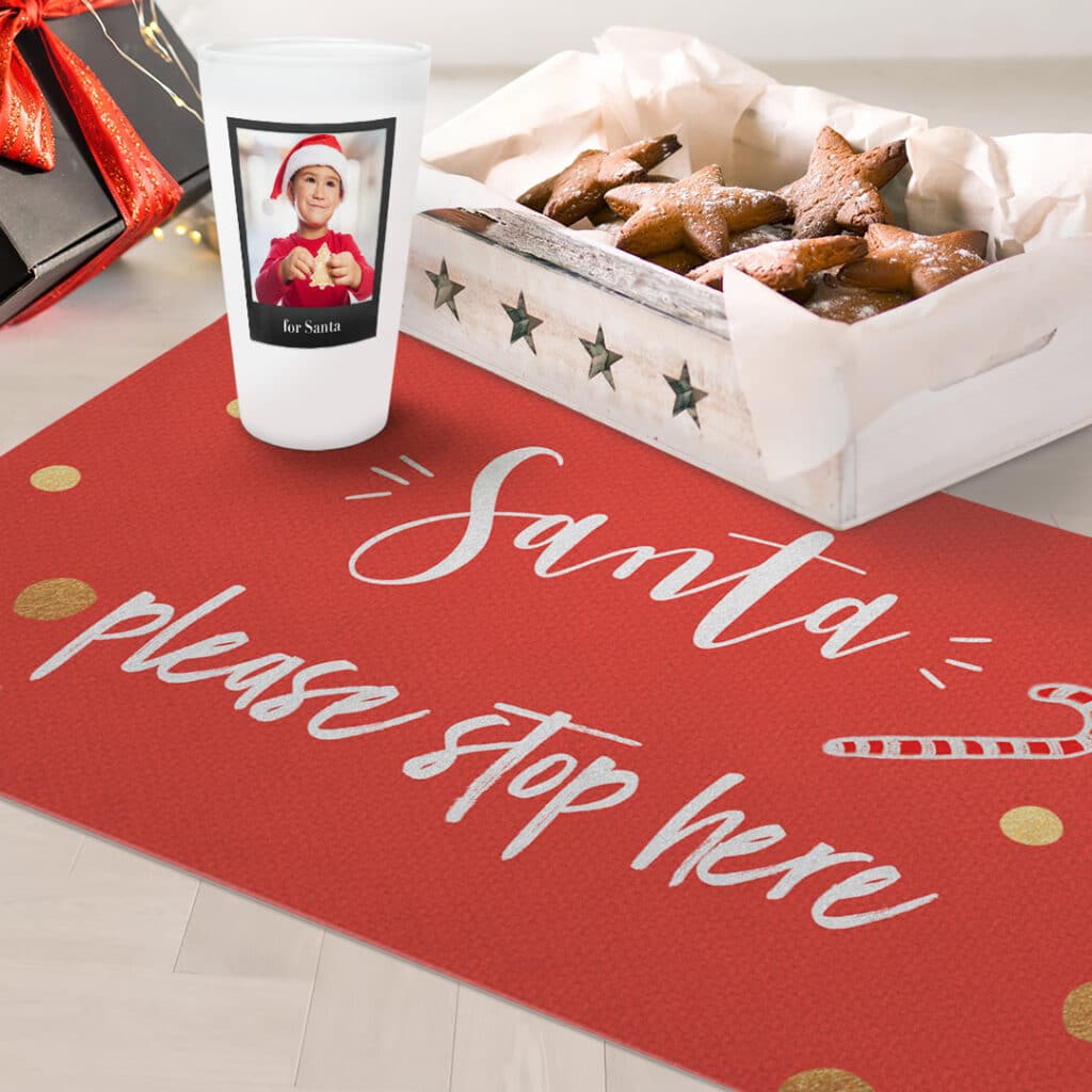 Frosted pint glass and personalised door mat with a box of cookies on the floor