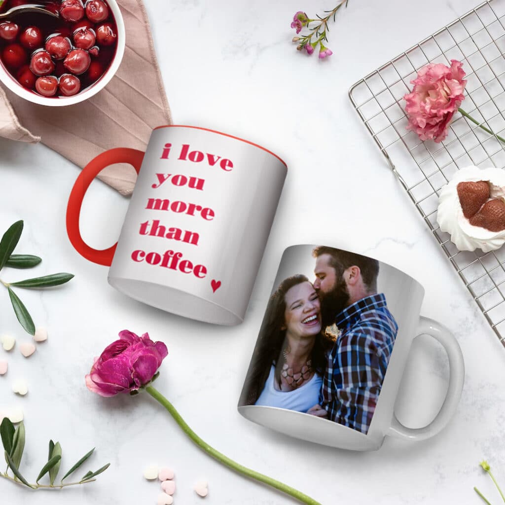 2 mugs laying on a kitchen counter with flowers