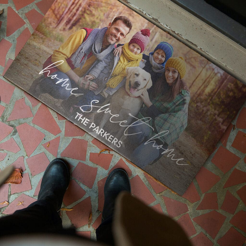 A personalised door mat with a family and their pet