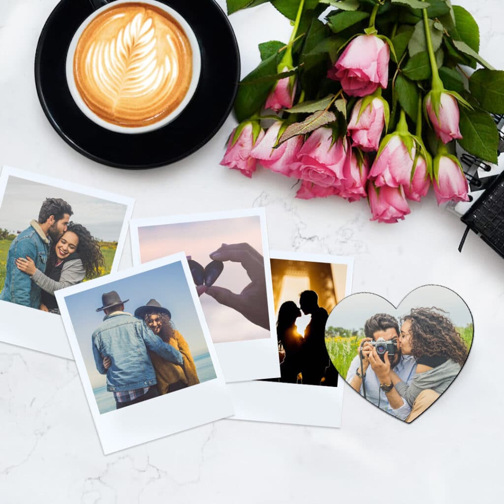 retro prints and a heart magnet on a worktop with a coffee mug and roses