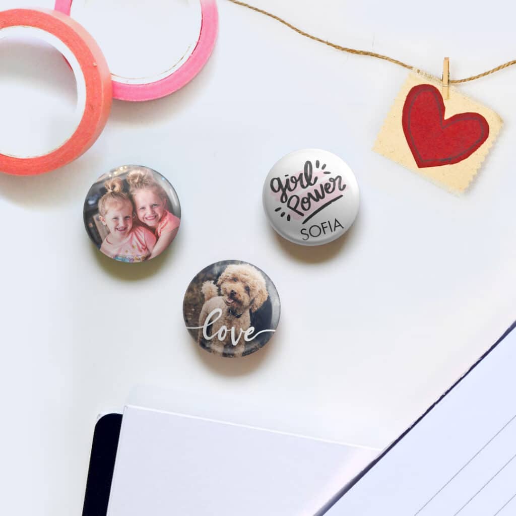 three button pin badges on a table