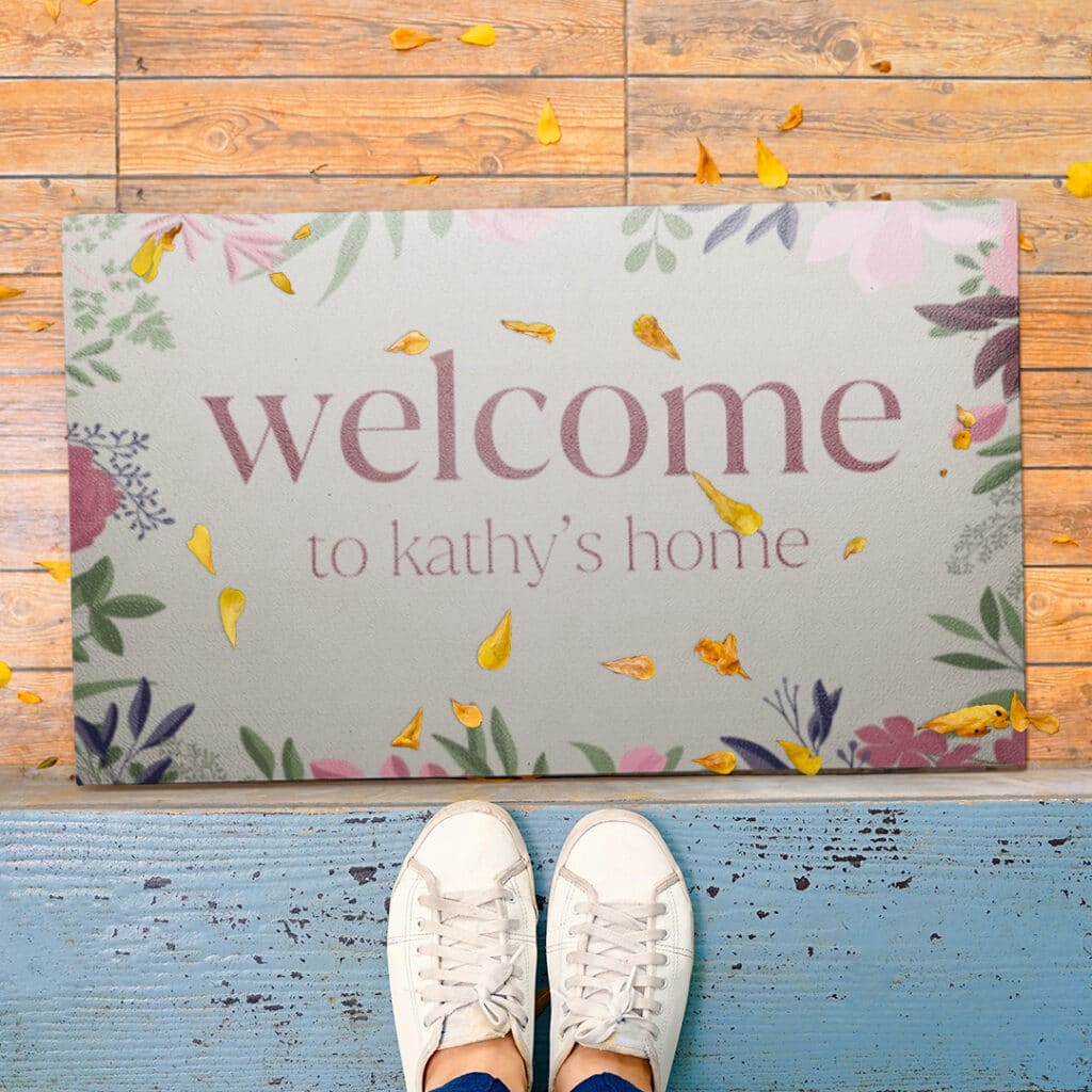 Someone in trainers standing in front of a personalised door mat.